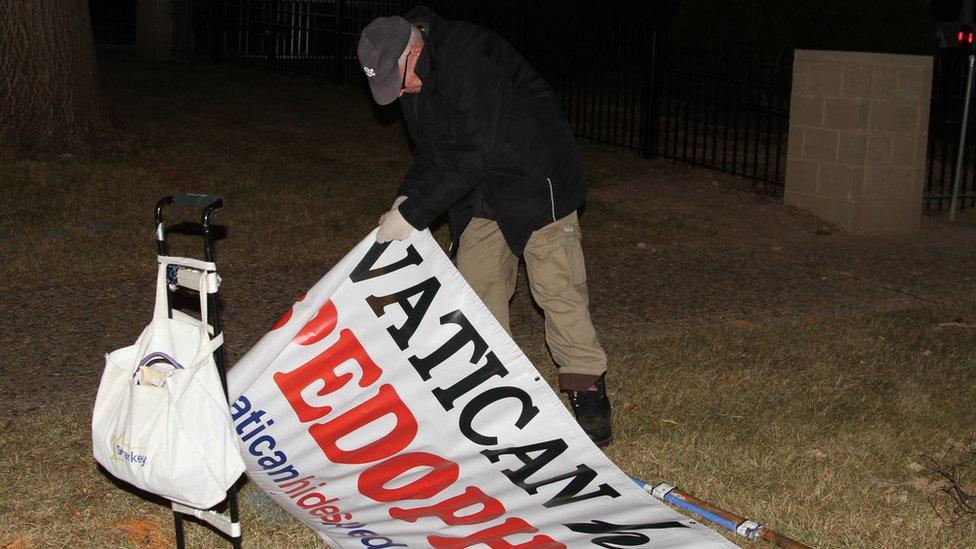 John erecting his banner.