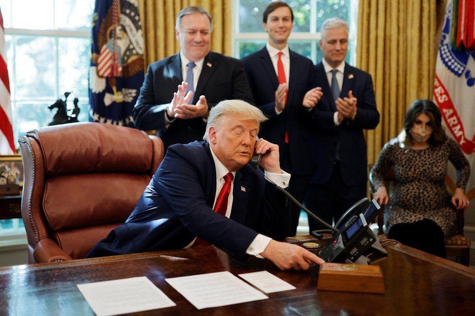 Donald Trump on the phone in the Oval Office