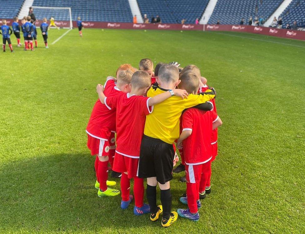 Cliftonville's future stars have a huddle on the pitch at West Brom