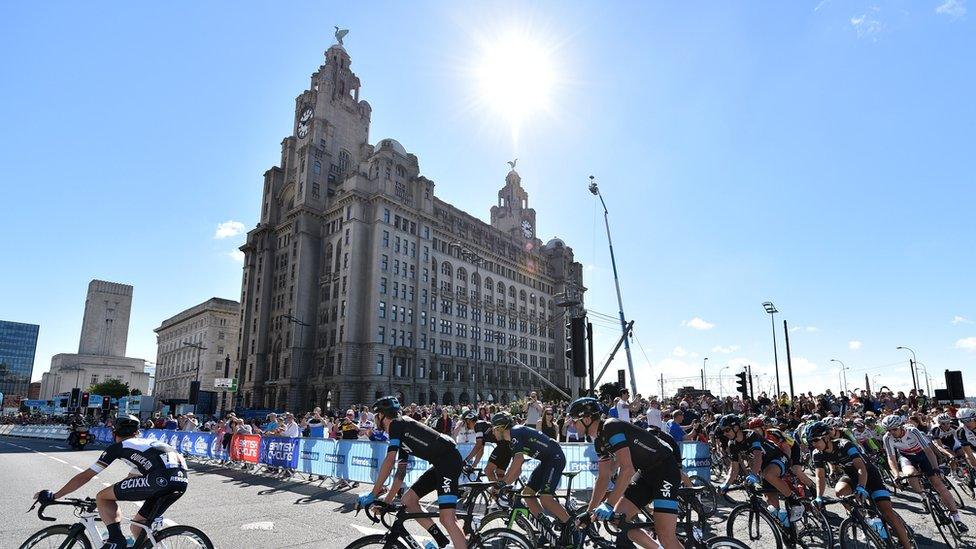 The riders start the race in front of the Royal Liver Building, on the streets of Liverpool during the 104.8 km first stage of the Tour of Britain cycle race on September 7, 2014