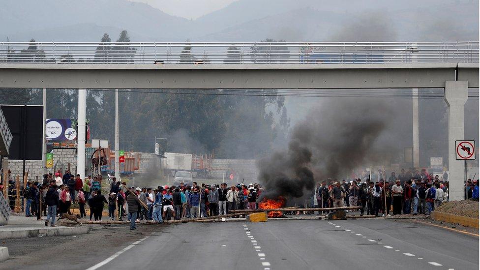 Protesters block a road