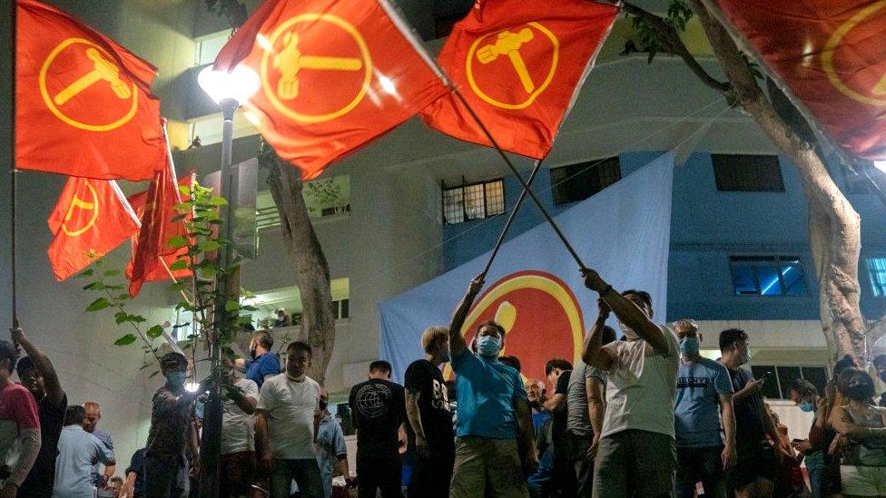 Supporters of opposition Workers Party wave the party flags in celebration