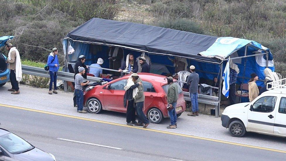 Israeli settlers gather at the site where Raziel Shevach was shot in a drive-by shooting near Nablus, in the occupied West Bank (10 January 2018)