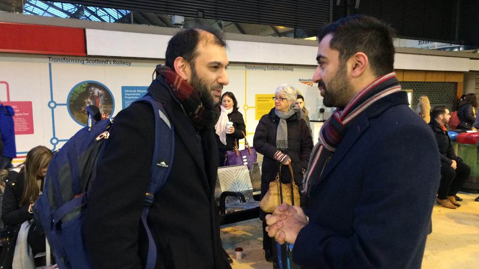 Humza Yousaf talking to passengers