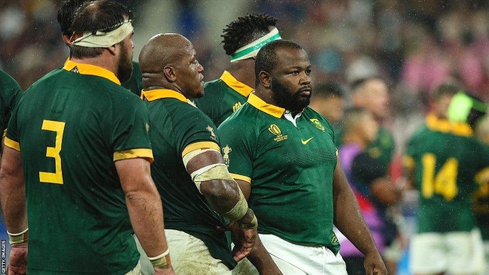 Ox Nche of South Africa stands with other Springbok front row players during the World Cup semi-final against England