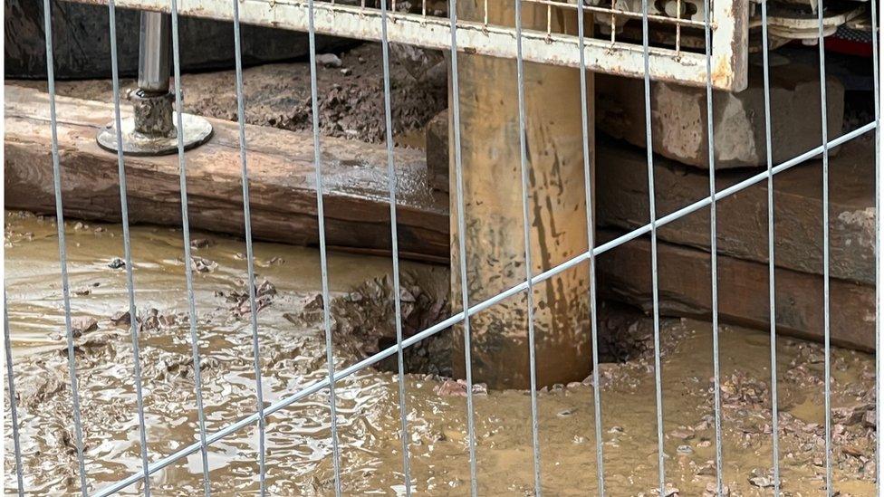 A bore hole into the silt of the ponds.