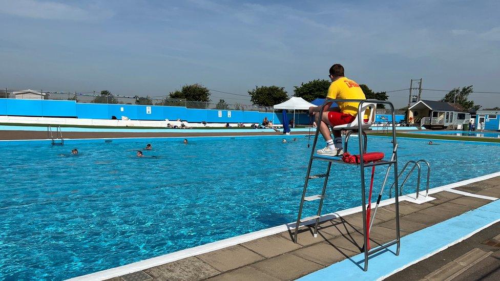 Lifeguard and people swimming at Brightlingsea Lido