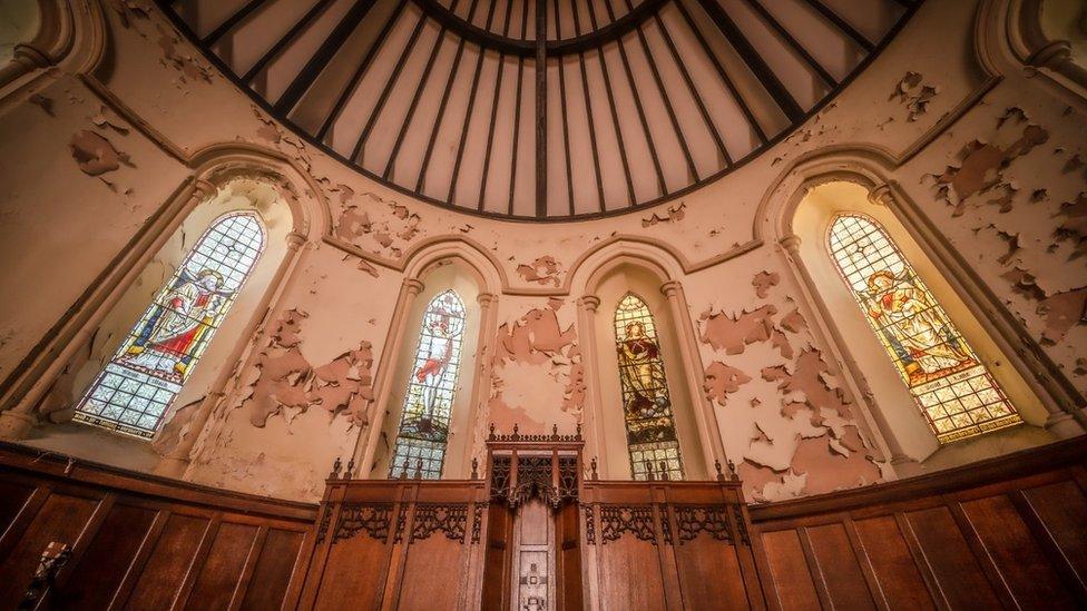 Stained windows and peeling paintwork inside Christ Church, Maryport