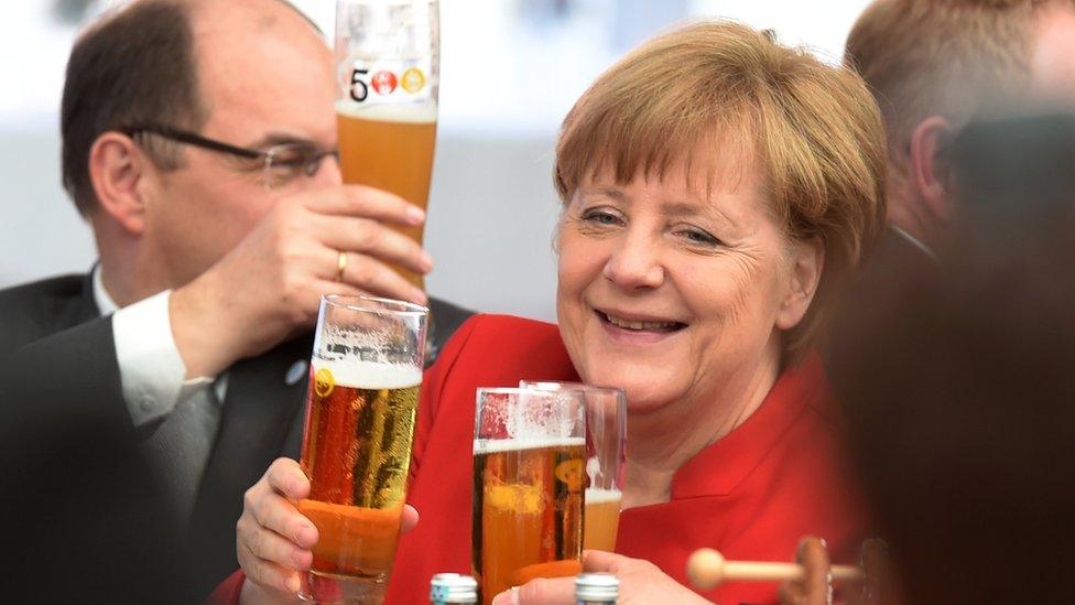 German Chancellor Angela Merkel (c) drinks beer during the 500th anniversary ceremony of the German Beer Purity Law (Reinheitsgebot) in Ingolstadt, Germany (22 April 2016)