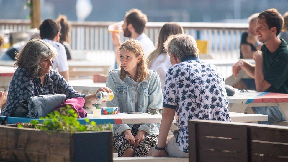 People relax in outdoor dining areas