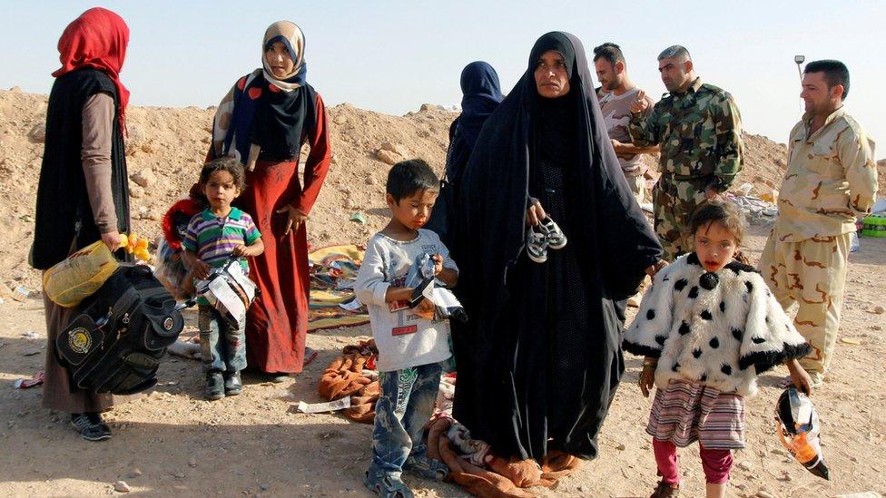 Displaced Iraqi people who fled from Al-Riyadh district arrive to be transported to camps for displaced people, southwest of Kirkuk