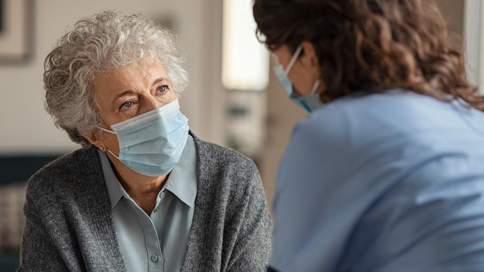 Stock image of an elderly woman with a care worker