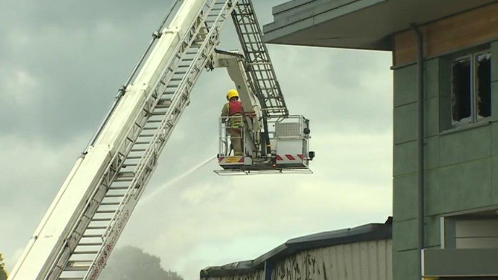 A firefighter on a crane