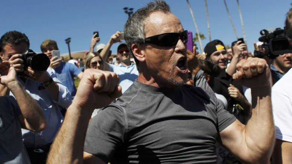 A supporter of Republican US presidential candidate Trump yells at anti-Trump demonstrators during a Trump campaign rally in Fountain Hills, Arizona