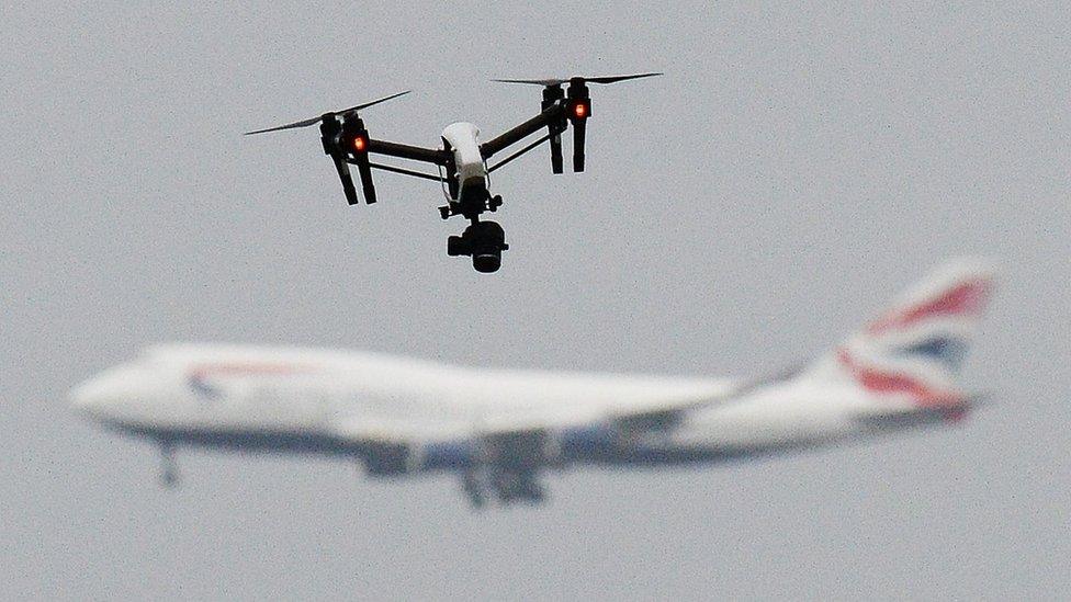 Drone flies in foreground as British Airways plane can be seen in the background