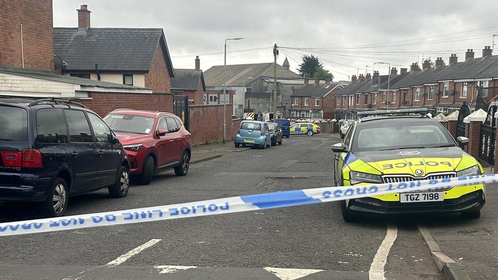 Police car and cordon at security alert