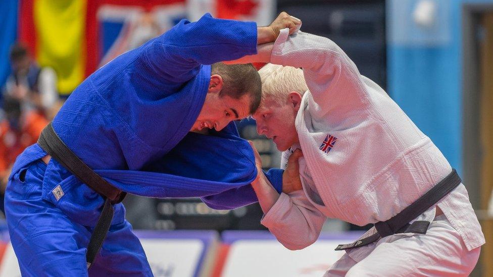 Evan Molloy in a judo fight wrestling another man