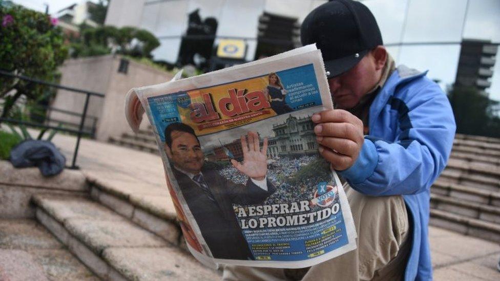 A man reads a newspaper in Guatemala City on 26 October, 2015, the day after general elections