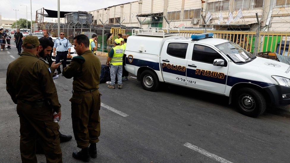 Israeli security forces personnel stand outside the factory in the Barkan Industrial Zone, in the occupied West Bank, where two Israelis were shot dead on 7 October 2018