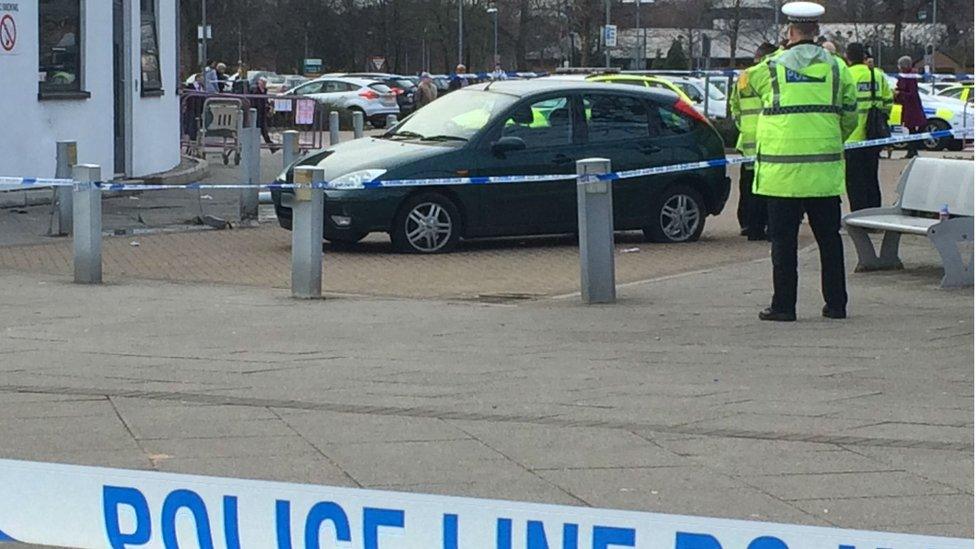 Police near car at scene