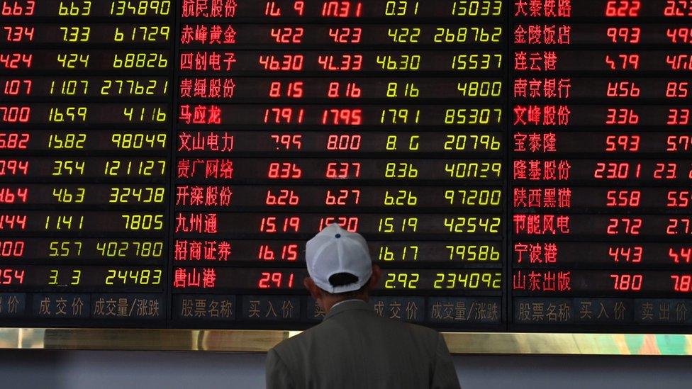 A man looks at stock market data in Shanghai