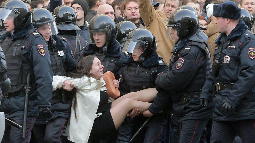 Russian riot policemen detain a demonstrator during an opposition rally in central Moscow, Russia, 26 March 2017