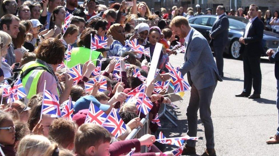 Prince Harry meets well-wishers as he arrives for a visit to the Barton Neighbourhood Centre