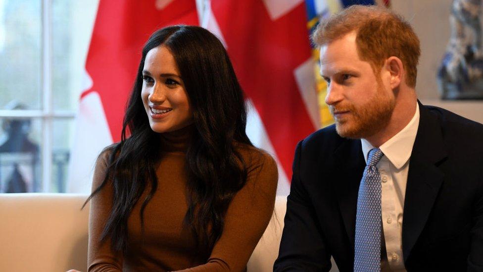 Prince Harry, Duke of Sussex and Meghan, Duchess of Sussex gesture during their visit to Canada House.