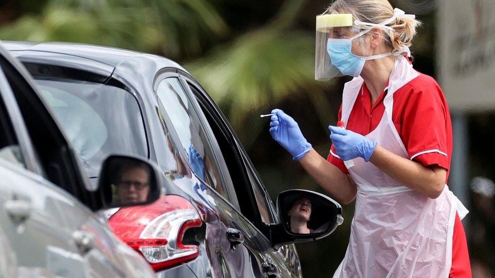 Health worker testing people for coronavirus