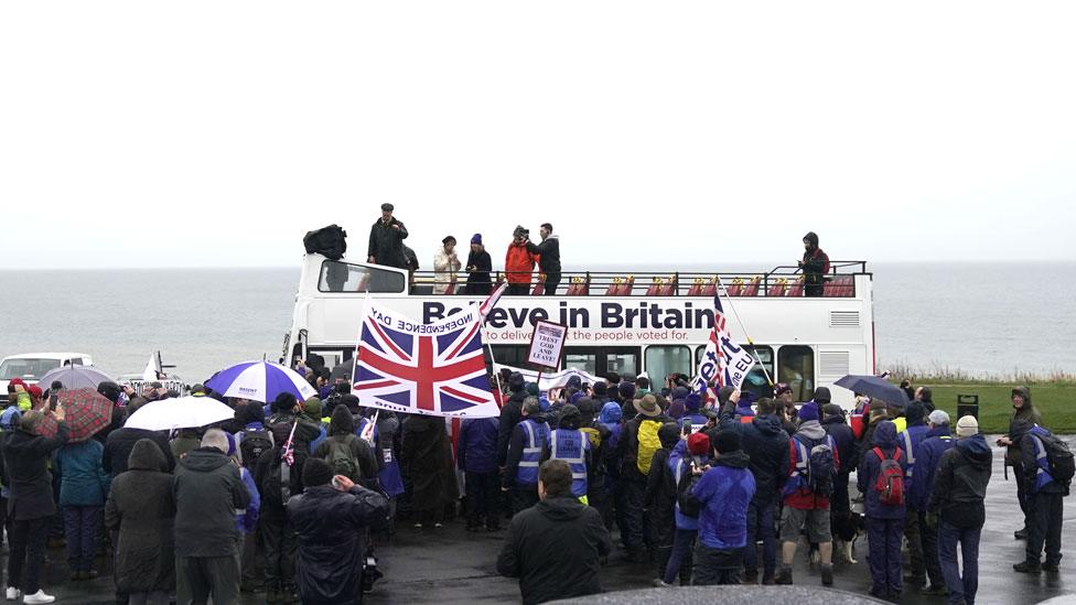 Nigel Farage makes a speech to marchers from the top of an open top bus