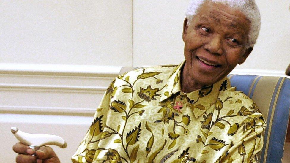 Former South African President Nelson Mandela meets with US President George W. Bush (not shown) in the Oval Office of the White House 17 May 2005