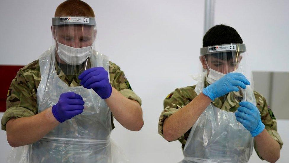 Two people handle test samples