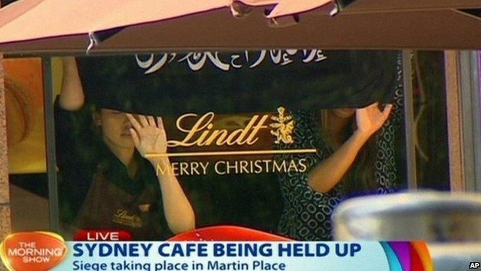 Hostages hold a banner during the Sydney cafe siege (December 2014)