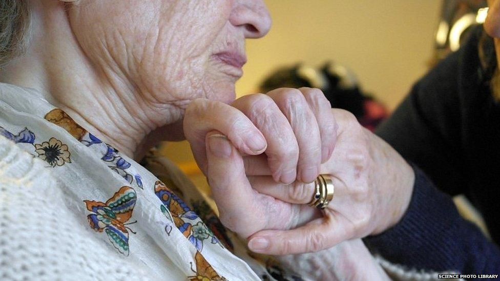 An elderly woman being cared for at home