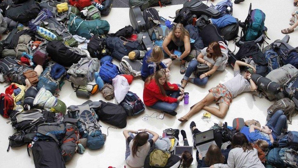 Passengers wait to find out if their flight to Guatemala is on time or cancelled at Hartsfield Jackson Atlanta International Airport (08 August 2016)