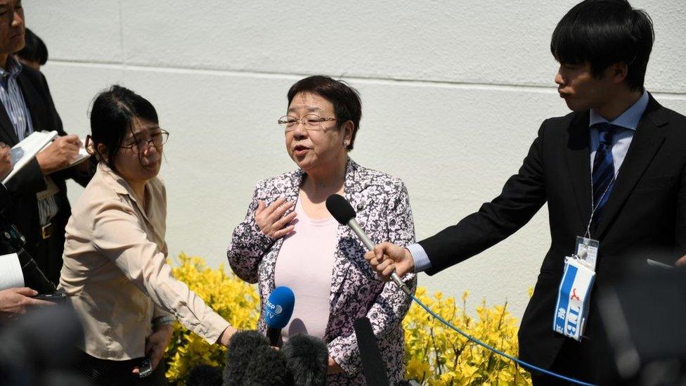 Mayor Tomoko Nakagawa speaks to reporters about her protest against the sumo policy