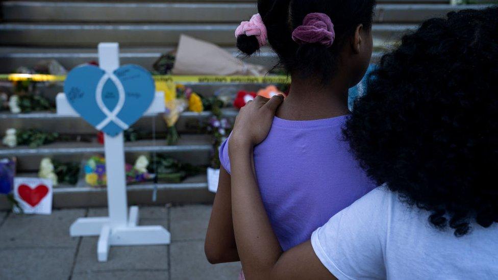 Two girls at the memorial outside of the Old National Bank in Louisville, Kentucky