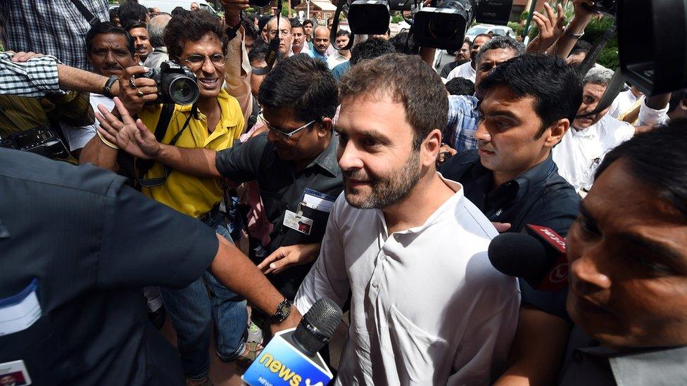 Congress Party Vice President Rahul Gandhi (C) speaks to the media as he arrives at the parliament building in New Delhi on July 22, 2015. The three-week long monsoon session of the Indian parliament began on July 22, with the ruling Bharatiya Janata Party's (BJP) intent on discussing three bills land acquisition, goods and services (GST) tax, and revision of labour laws