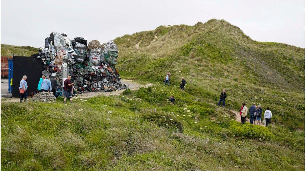 A statue of Johnson, Biden and other world leaders has been erected on the iconic cliffs