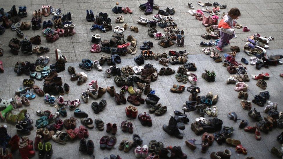 A young girl looks through shoes donated by the people of Hungary at Keleti station on September 7, 2015 in Budapest, Hungary