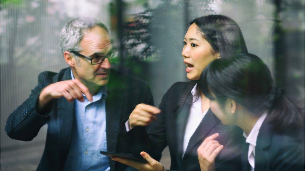 man and two women in business meeting