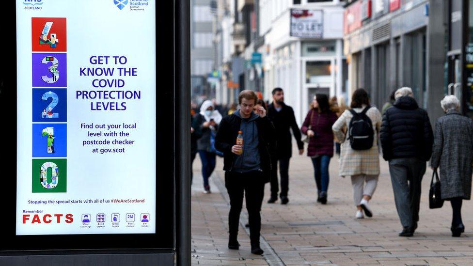 people-walking-along-scottish-highstreet.