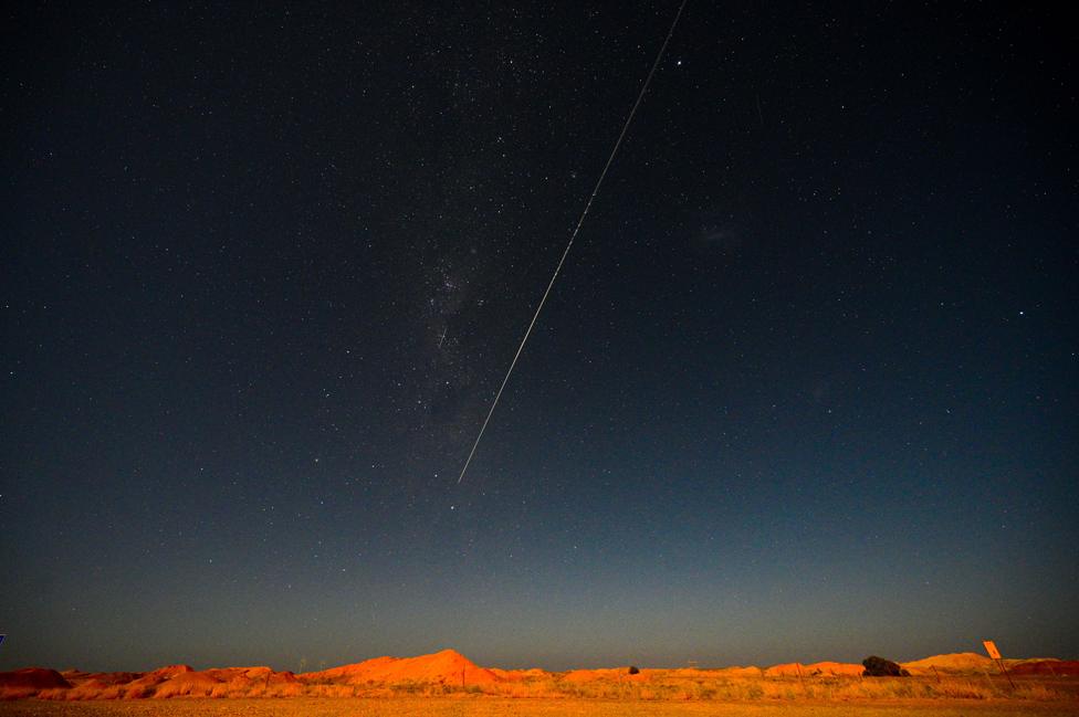 A capsule from Japan's Hayabusa-2 space probe streaks through the night sky