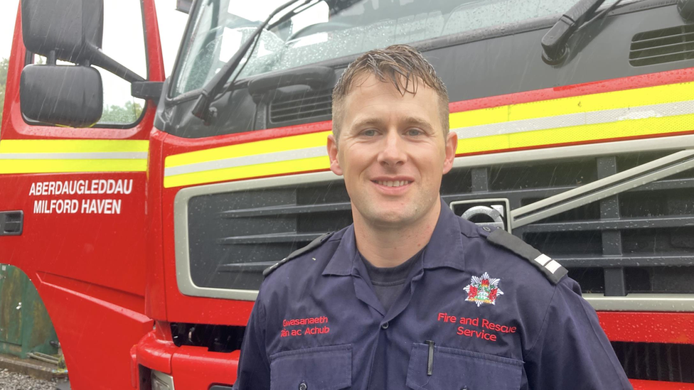 Luke Jenkins, a crew manager in Milford Haven, standing in front of a fire engine