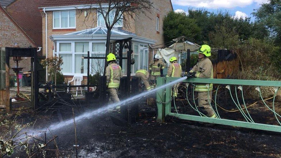 Firefighters putting out the garden fire in St Mellons