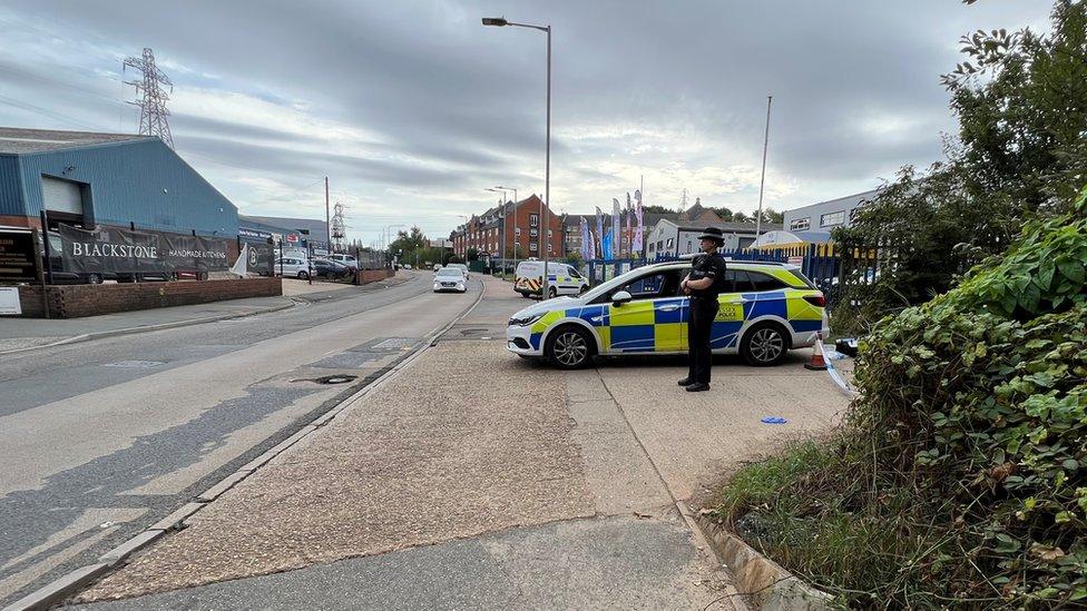 Havens Road in Colchester, with a police officer standing alongside a police car at the junction of Distillery Lane