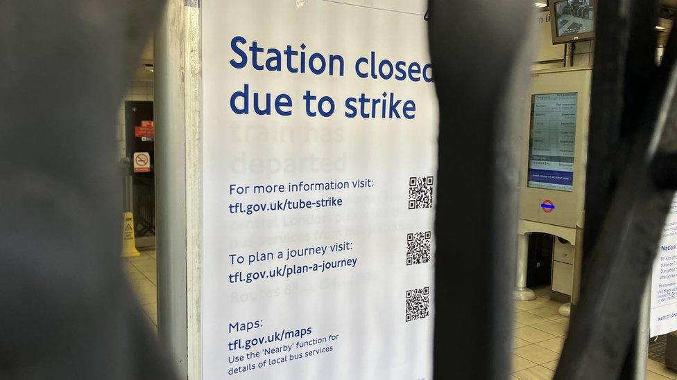 Kentish Town station closed sign behind gates