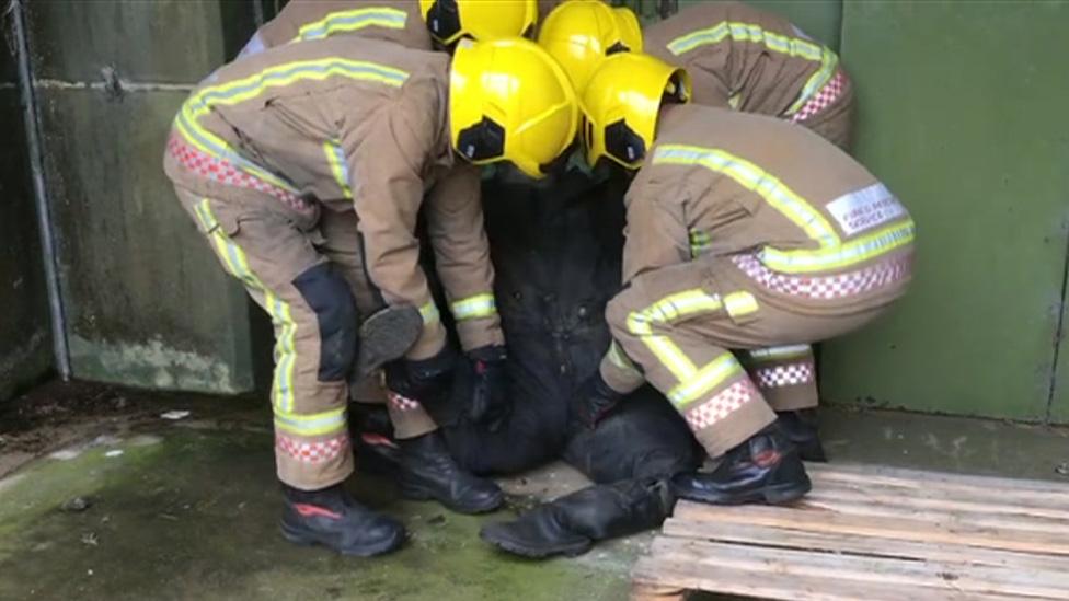 Firefighters with rescue dummy