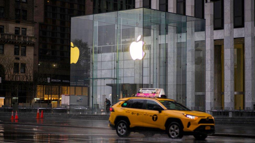 A taxi drives past Appl's headquarters in New York