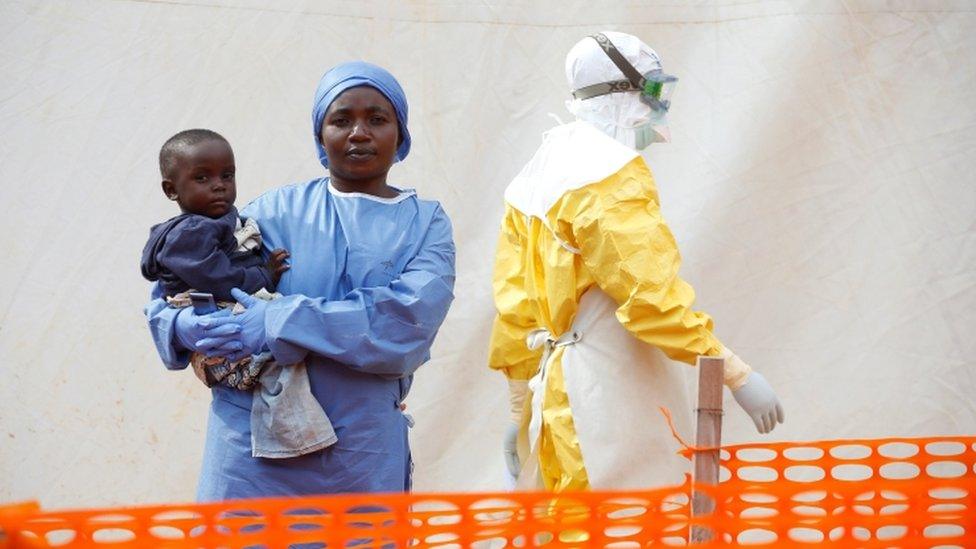 An Ebola survivor looking after a baby at an Ebola centre in DR Cong